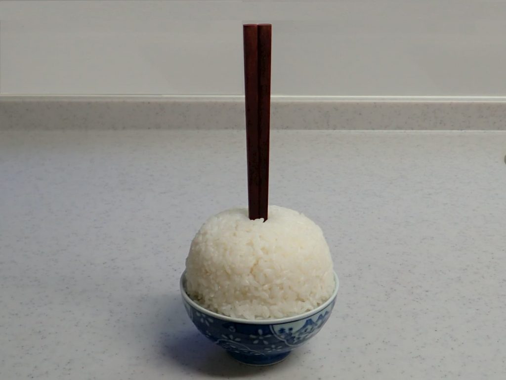 ChopsticksStickingStraightUpInRice