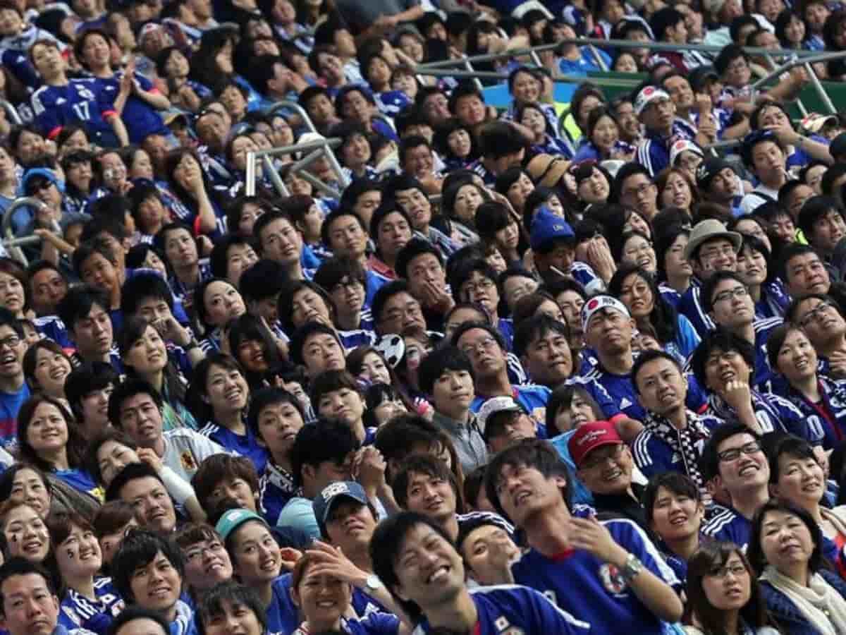 Japanese fans cleaning up the stadium after soccer match - Land Of The Rising Son